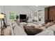 Spacious living room with comfortable seating, a fireplace, and large windows offering plenty of natural light at 213 Genesis Pl, Cleveland, NC 27013