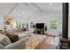 Bright living room boasts vaulted ceilings, wood floors, stylish rug, and comfortable seating at 213 Genesis Pl, Cleveland, NC 27013