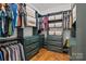Well-organized walk-in closet featuring custom shelving, drawers, hanging rods, and hardwood floors at 213 Genesis Pl, Cleveland, NC 27013