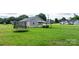 Spacious backyard featuring green grass, a trampoline, outdoor furniture under gazebo perfect for entertaining at 2411 28Th Ne St, Hickory, NC 28601