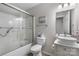 Well-lit bathroom featuring a vanity and glass-enclosed bathtub at 2411 28Th Ne St, Hickory, NC 28601
