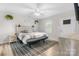 Bright bedroom featuring a stylish headboard, ceiling fan, and neutral decor at 2411 28Th Ne St, Hickory, NC 28601