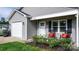 Close-up of the home's entrance featuring rocking chairs, a small garden, and a view of the attached garage at 2411 28Th Ne St, Hickory, NC 28601