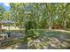 Spacious backyard with a patio, mature trees, and a large lawn, perfect for outdoor entertaining and relaxation at 2522 Doster Rd, Monroe, NC 28112