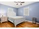 Cozy bedroom featuring hardwood floors, a ceiling fan and two windows offering natural light at 2522 Doster Rd, Monroe, NC 28112