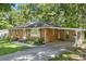 View of a single-story brick home with a carport, showcasing its well-kept landscaping and design at 2522 Doster Rd, Monroe, NC 28112