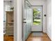 Bright foyer with hardwood floors, a decorative cabinet, and a view of the outdoors through the front door at 2522 Doster Rd, Monroe, NC 28112
