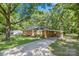 Inviting brick home with a covered carport, set back on a lot with mature trees and a long driveway at 2522 Doster Rd, Monroe, NC 28112