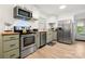 Well-lit kitchen with stainless steel appliances, wooden countertop and muted green cabinetry at 2522 Doster Rd, Monroe, NC 28112