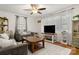 Comfortable living room with hardwood floors, a ceiling fan, and a view of the natural light through sheer curtains at 2522 Doster Rd, Monroe, NC 28112