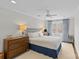 Cozy bedroom with a large window, ceiling fan, and traditional dresser at 2814 Glendale Rd, Charlotte, NC 28209