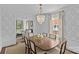 Chic dining area flows into the living room, complete with a chandelier and wallpaper at 2814 Glendale Rd, Charlotte, NC 28209