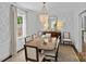 Sophisticated dining room with chandelier, stylish wallpaper, and window at 2814 Glendale Rd, Charlotte, NC 28209