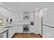 Modern kitchen with white cabinets, stainless steel appliances, and granite countertops at 2814 Glendale Rd, Charlotte, NC 28209