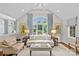 Bright living room features vaulted ceiling, a large window, and a comfortable seating area at 2814 Glendale Rd, Charlotte, NC 28209