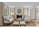 Elegant living room featuring a fireplace, neutral color palette, and ample natural light at 2814 Glendale Rd, Charlotte, NC 28209