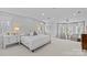 Bright and airy main bedroom features a luxurious king bed, bay window, and soft lighting at 2814 Glendale Rd, Charlotte, NC 28209