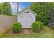 Backyard shed with double doors and decorative bushes provides extra storage and complements the landscaped yard at 2814 Glendale Rd, Charlotte, NC 28209