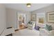 Bright sitting room features neutral tones, large window and doorway to the Gathering room beyond at 2814 Glendale Rd, Charlotte, NC 28209