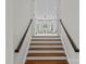 Staircase leading up to a living area with white draperies and comfortable seating at 2814 Glendale Rd, Charlotte, NC 28209