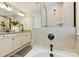 Bathroom featuring dual sinks, granite counters, and a glass-enclosed shower at 2844 Georgia Ave, Charlotte, NC 28205