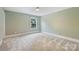 Bedroom with green walls, carpet flooring, and a window view at 2844 Georgia Ave, Charlotte, NC 28205