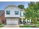 Charming two-story home with a two-car garage, stone accents, blue shutters, and manicured landscaping at 2844 Georgia Ave, Charlotte, NC 28205