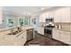 Well-lit kitchen featuring stainless steel appliances and stone countertops at 2844 Georgia Ave, Charlotte, NC 28205