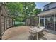 Open-air patio area with pergola, dining set, privacy screen, and view of the home's exterior at 2844 Georgia Ave, Charlotte, NC 28205