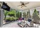 Relaxing screened-in sunroom with ceiling fan, modern furnishings, and a serene view of the lush landscaping at 2844 Georgia Ave, Charlotte, NC 28205