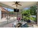 Relaxing screened-in sunroom with ceiling fan, TV, and view of the outdoor patio and landscaped backyard at 2844 Georgia Ave, Charlotte, NC 28205