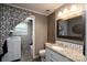 Updated bathroom featuring a granite vanity and adjacent laundry room at 318 Confederate Sw Dr, Concord, NC 28027