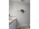 Well-maintained bathroom with tiled flooring, hexagon wall decor, and a white vanity at 318 Confederate Sw Dr, Concord, NC 28027