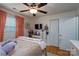 Comfortable bedroom with hardwood floors, a ceiling fan, and double closets at 318 Confederate Sw Dr, Concord, NC 28027