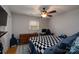 Bedroom with a ceiling fan, hardwood flooring, closet, and a desk with computer at 318 Confederate Sw Dr, Concord, NC 28027