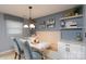 Dining area with white built-in bench seating, updated lighting and wall shelves at 318 Confederate Sw Dr, Concord, NC 28027