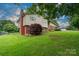 Exterior elevation showcasing the home and well-manicured landscaping at 318 Confederate Sw Dr, Concord, NC 28027
