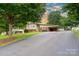 Charming home featuring a carport, brick accents, and a well-maintained front yard at 318 Confederate Sw Dr, Concord, NC 28027