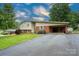 Charming home featuring a carport, brick accents, and a well-maintained front yard at 318 Confederate Sw Dr, Concord, NC 28027