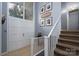 Welcoming foyer with natural light, staircase, tiled floor, and a charming decorative display shelf with double doors at 318 Confederate Sw Dr, Concord, NC 28027