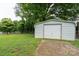 Outbuilding featuring a concrete driveway and lush green lawn at 318 Confederate Sw Dr, Concord, NC 28027