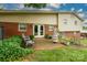 Back patio with an outdoor seating area and lush landscaping at 318 Confederate Sw Dr, Concord, NC 28027