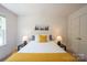 Bedroom featuring a comfortable bed, neutral decor, and a large window with natural light at 3403 Keith Dr, Charlotte, NC 28269