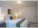 Comfortable bedroom featuring a queen bed, soft lighting, and minimalist decor at 3403 Keith Dr, Charlotte, NC 28269