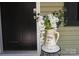 Charming front porch featuring a flower-filled pitcher and well-maintained door at 3403 Keith Dr, Charlotte, NC 28269