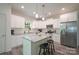 Modern kitchen featuring white cabinets, stainless steel appliances, a kitchen island with stool seating, and granite countertops at 3403 Keith Dr, Charlotte, NC 28269