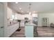 Open kitchen with white cabinets, granite countertops, a kitchen island, and stainless steel appliances at 3403 Keith Dr, Charlotte, NC 28269