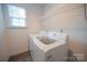 Functional laundry room featuring a modern washer and dryer set with ample storage shelving at 3403 Keith Dr, Charlotte, NC 28269
