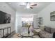 Comfortable living room with modern furnishings, a ceiling fan, and gray wood flooring throughout the home at 3403 Keith Dr, Charlotte, NC 28269