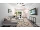 Cozy living room with large window, modern furnishings, stylish rug, and gray wood flooring throughout the home at 3403 Keith Dr, Charlotte, NC 28269